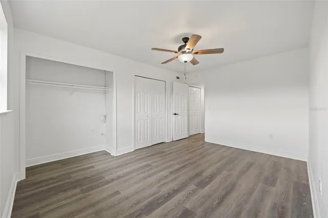 a view of an empty room and wooden floor