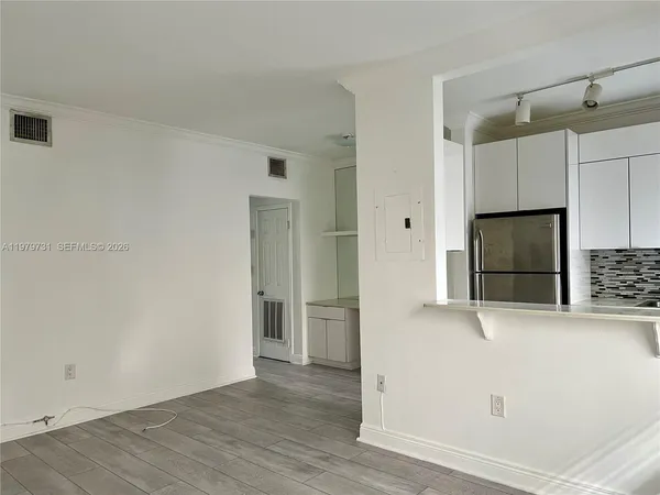 a view of a refrigerator in kitchen and wooden floor
