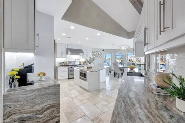a kitchen with lots of counter top space and furniture