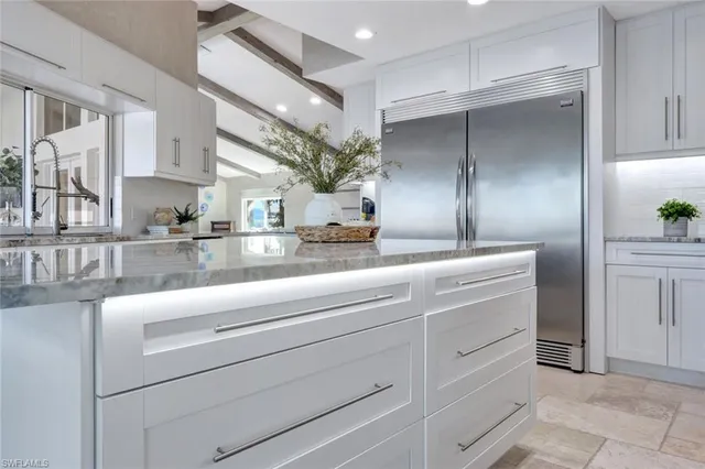 a kitchen with cabinets and stainless steel appliances