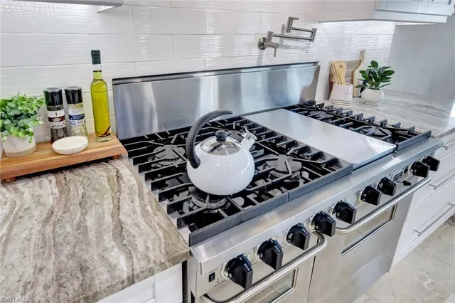 a stove top oven sitting inside of a kitchen