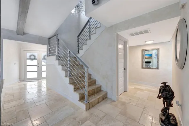 a view of entryway and hall with a front door