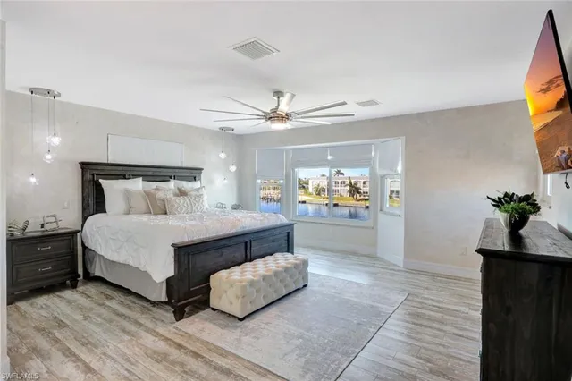 a bedroom with a bed and a chandelier
