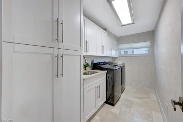 a view of a kitchen with white cabinets
