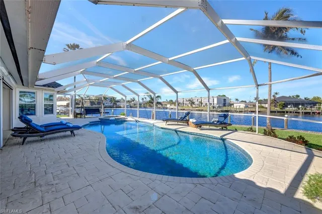 a view of a swimming pool with sitting area