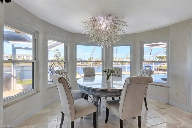a view of a dining room with furniture wooden floor and chandelier