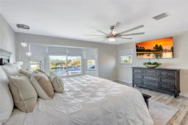 a bedroom with furniture and a flat screen tv