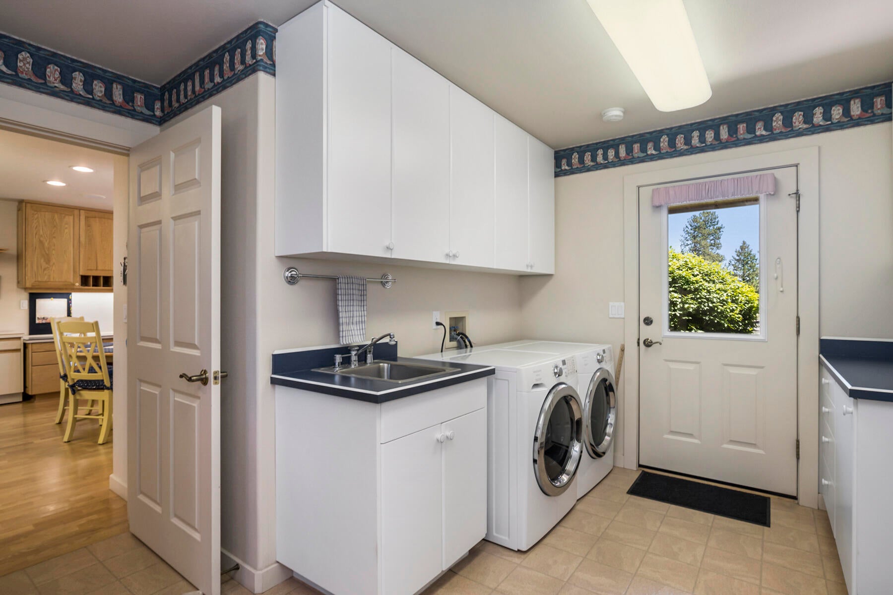 60696 Tekampe Road Bend, OR 97702 - Photo 37 of 61 Utility/Laundry room off kitchen with door to back patio.