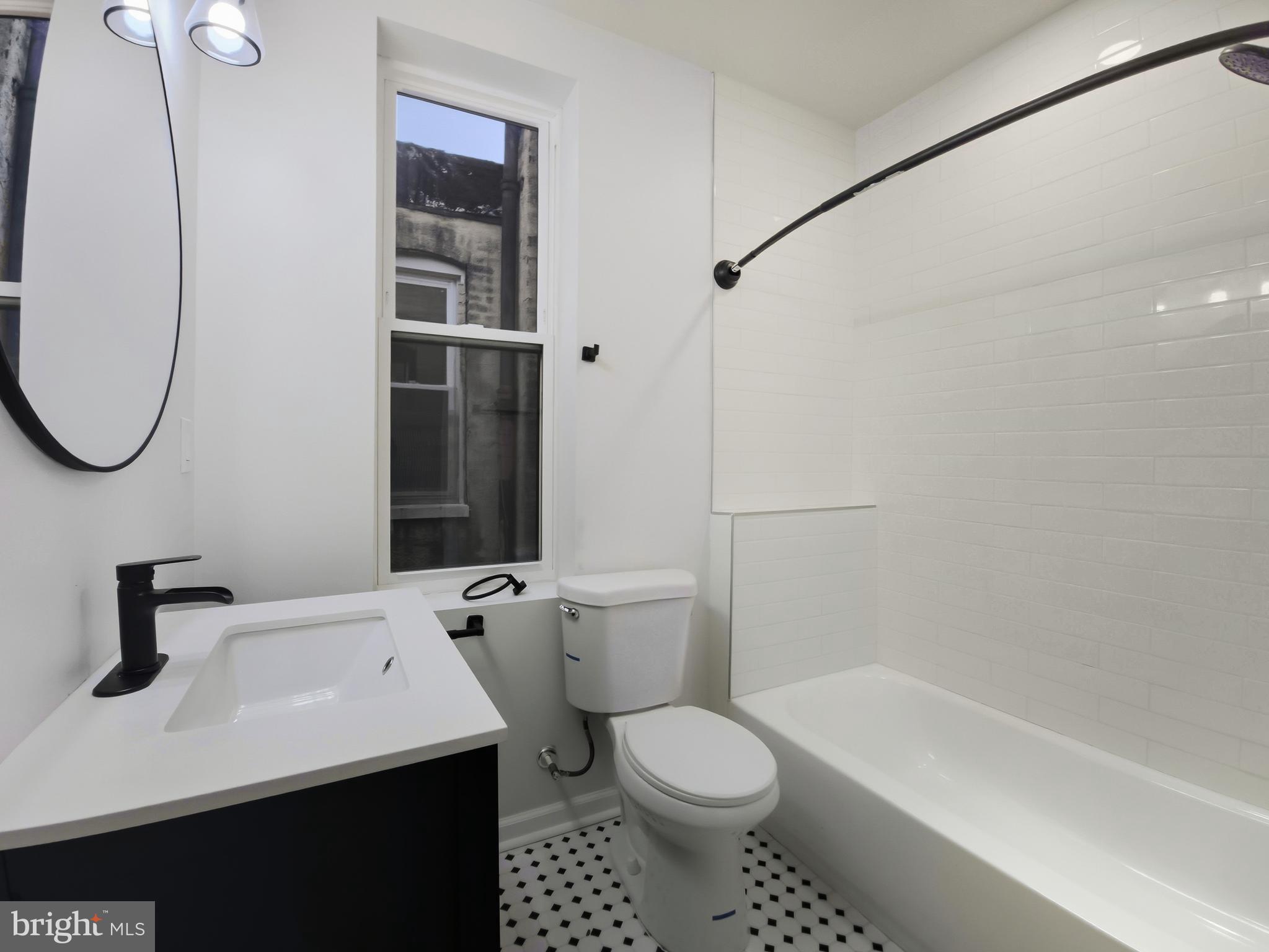 2321 McCulloh Street Baltimore, MD 21217 - Photo 16 of 29 a bathroom with a sink a toilet and shower