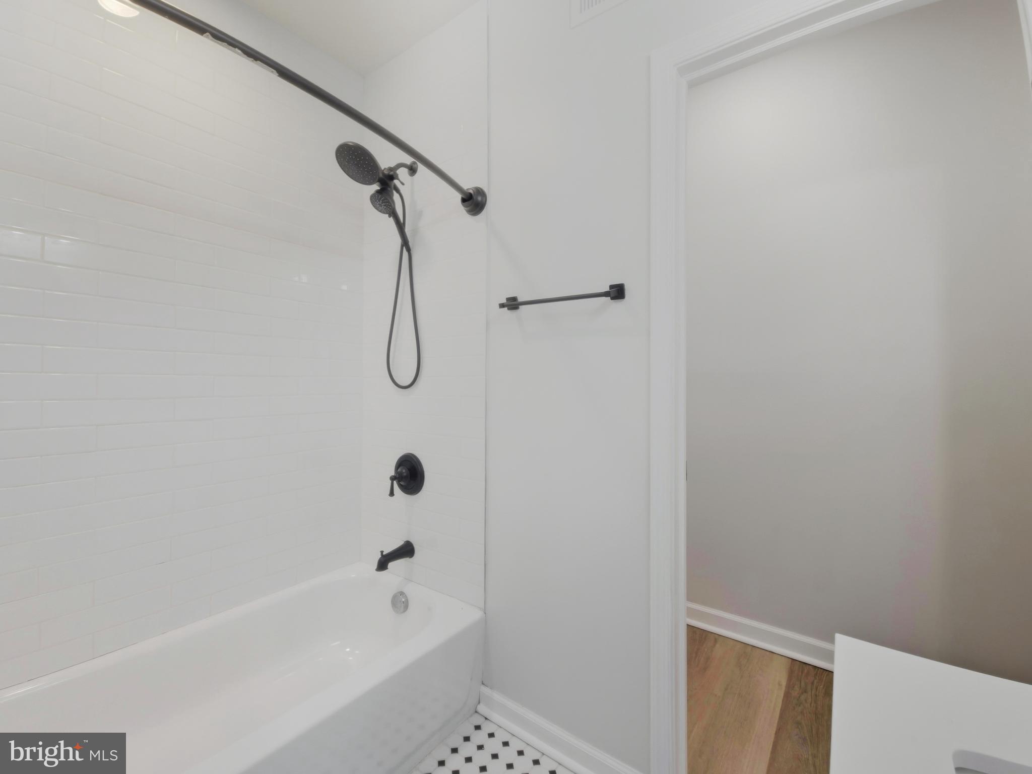 2321 McCulloh Street Baltimore, MD 21217 - Photo 17 of 29 a bathroom with a bath tub with a shower