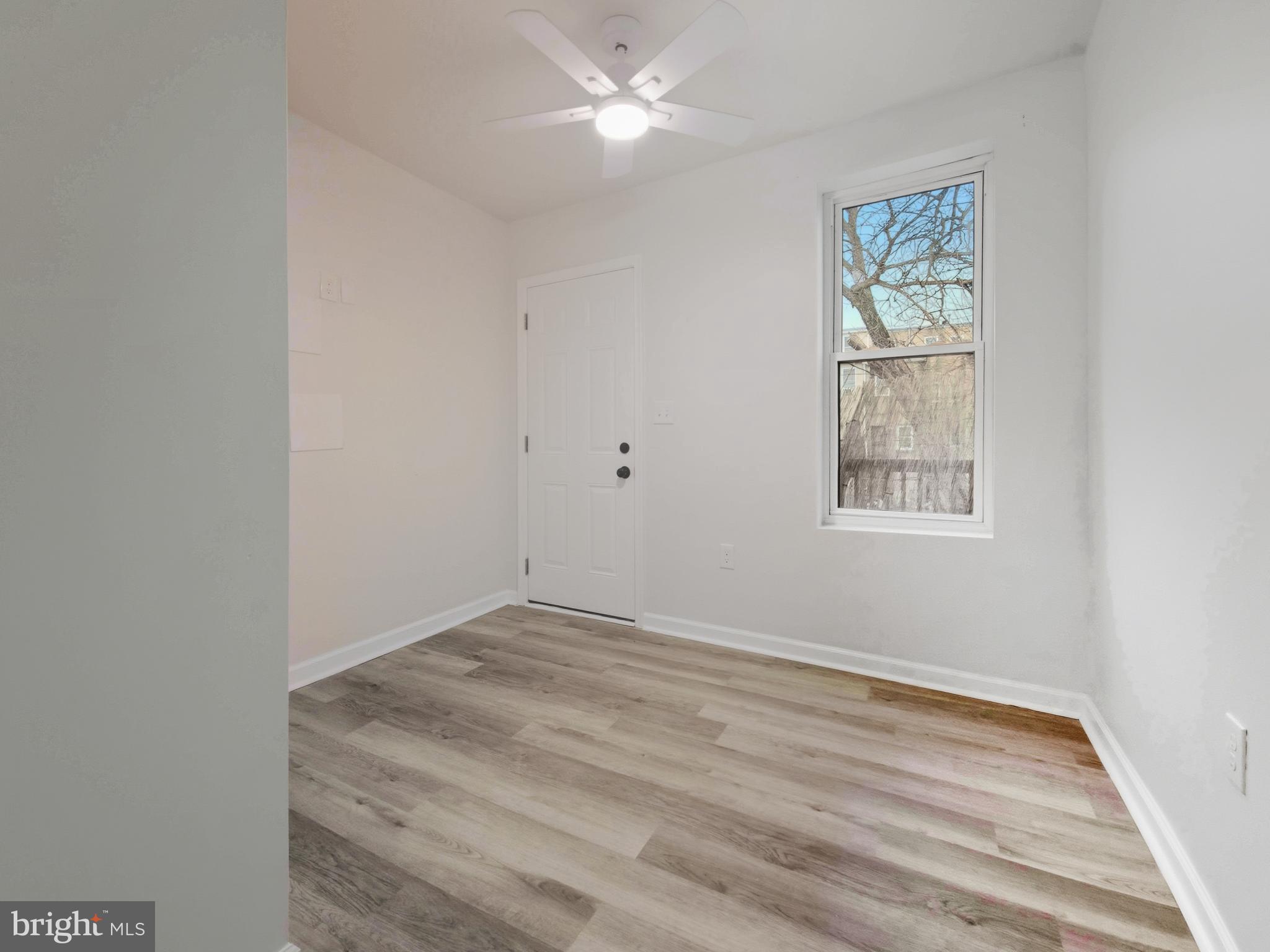 2321 McCulloh Street Baltimore, MD 21217 - Photo 18 of 29 an empty room with windows and fan