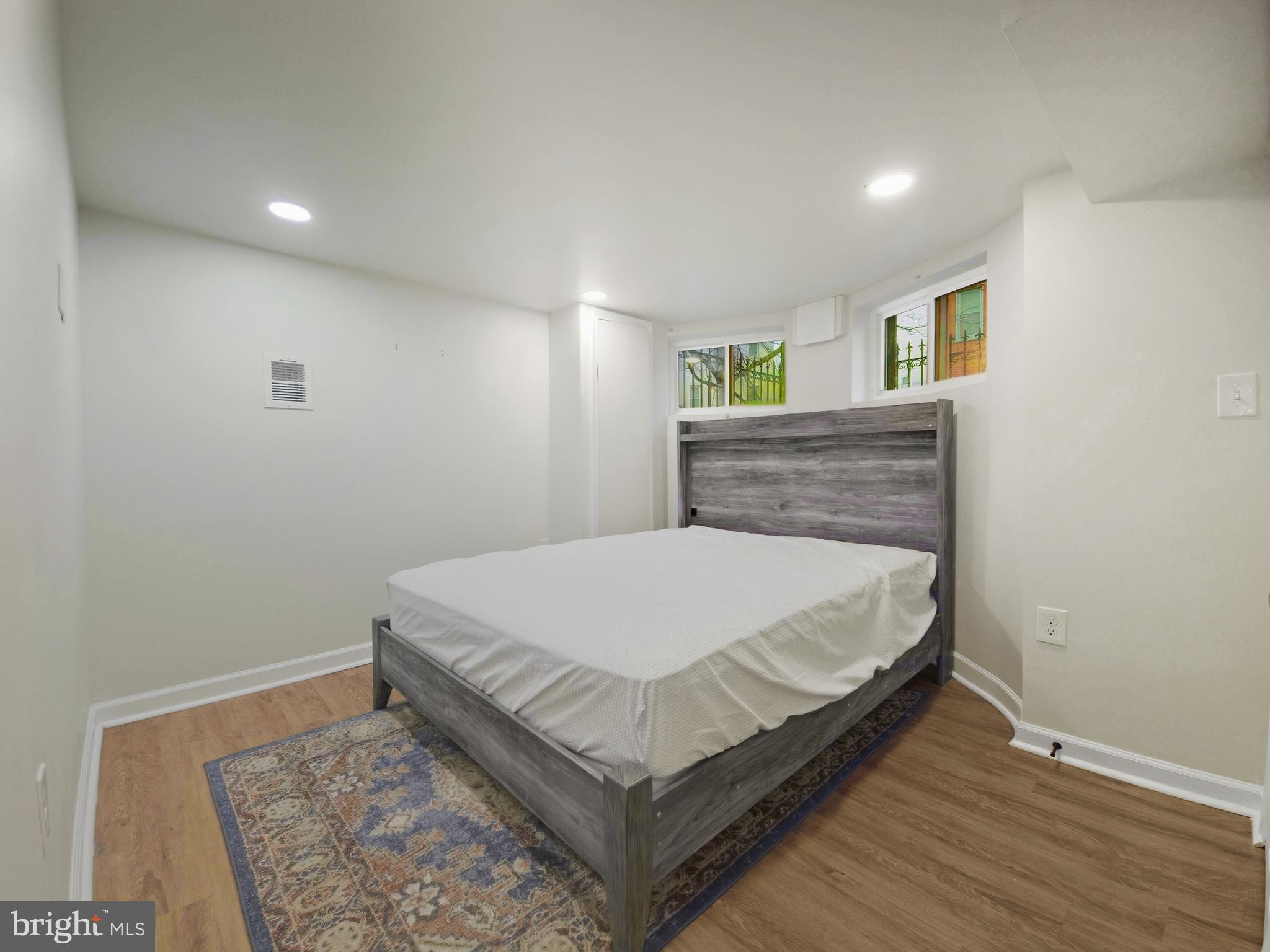 2321 McCulloh Street Baltimore, MD 21217 - Photo 20 of 29 a bed sitting in a spacious bedroom next to a window