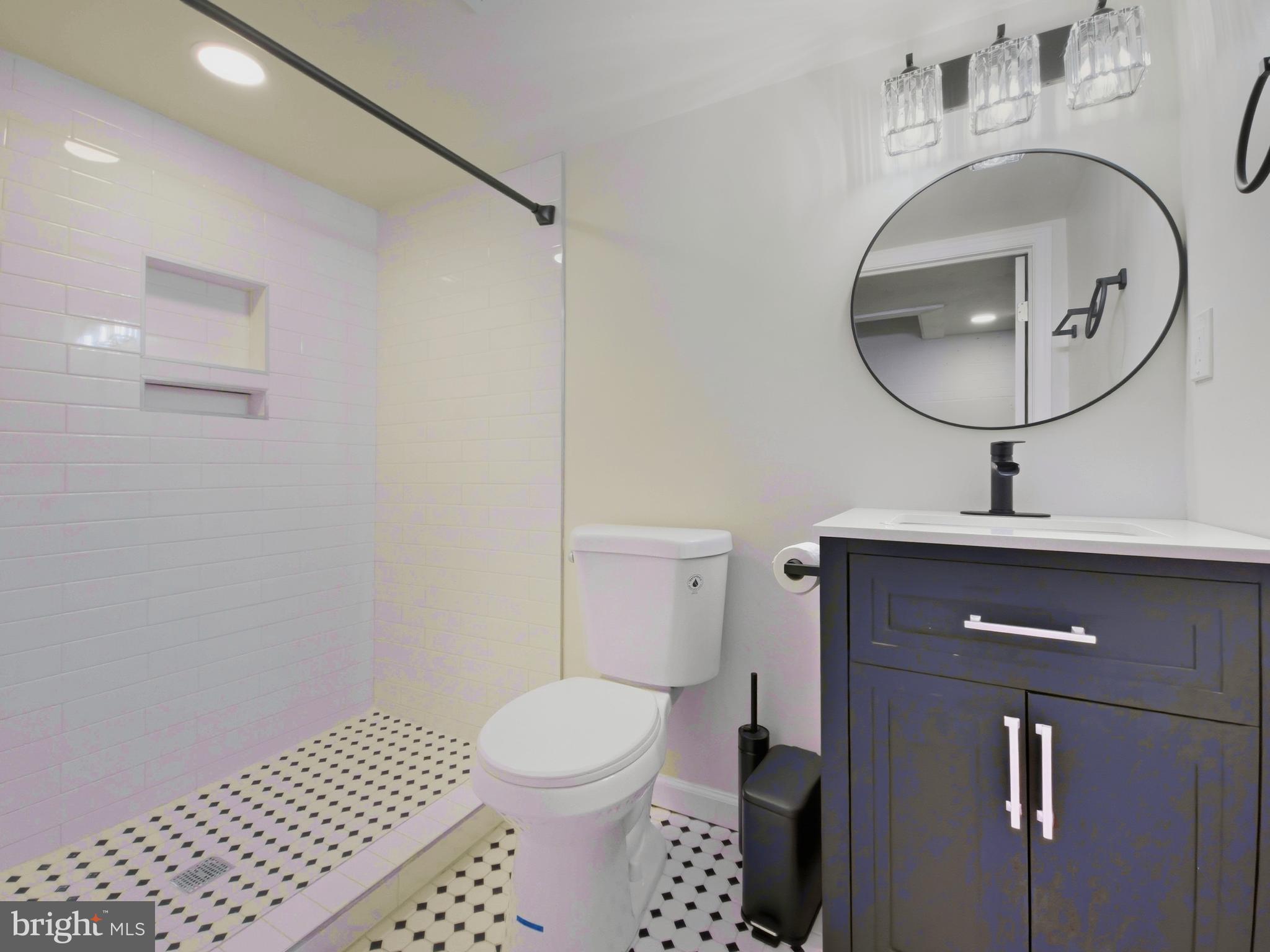 2321 McCulloh Street Baltimore, MD 21217 - Photo 21 of 29 a bathroom with a sink a toilet and a mirror