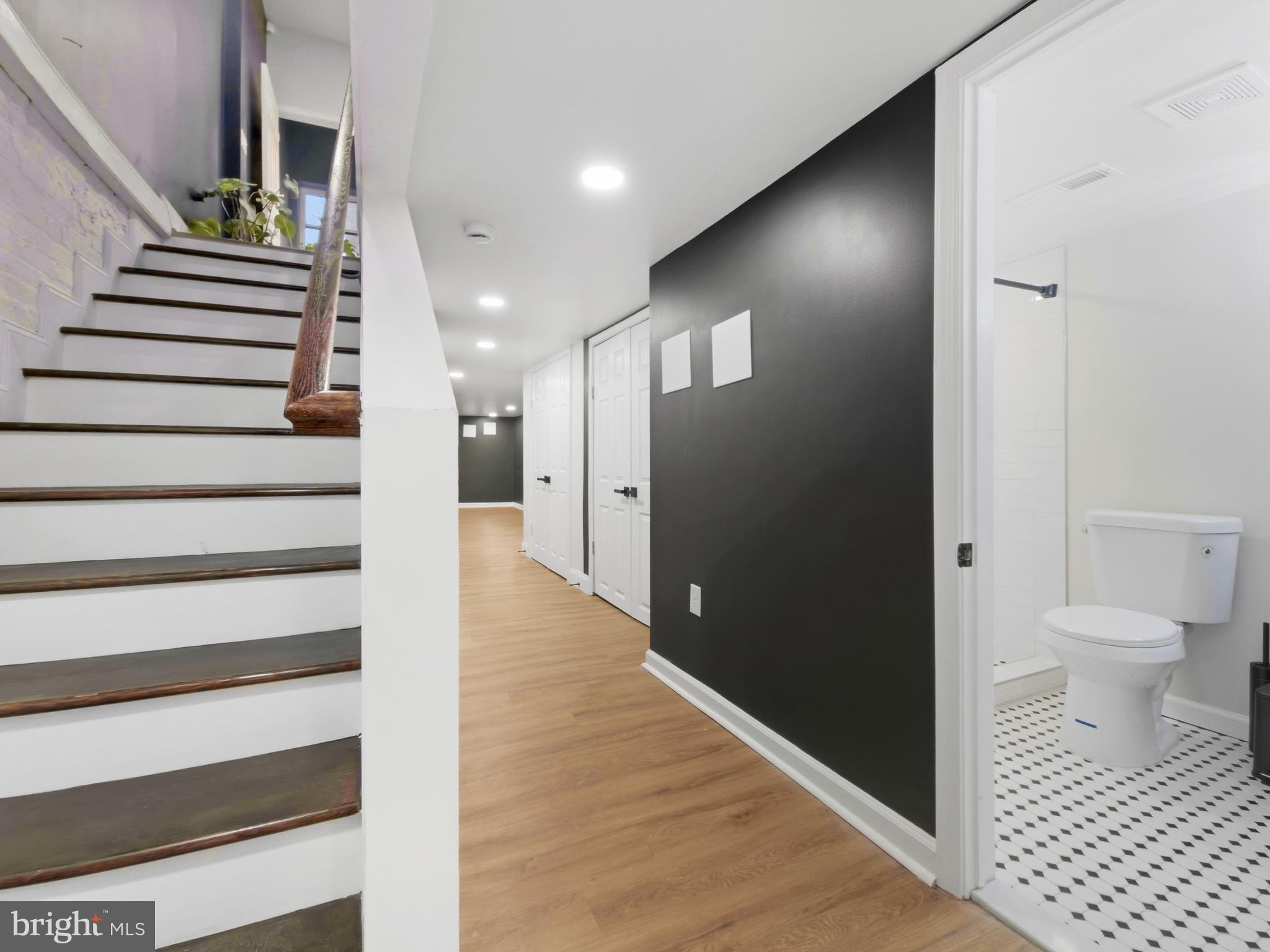 2321 McCulloh Street Baltimore, MD 21217 - Photo 22 of 29 a view of a hallway with wooden floor and a bathroom