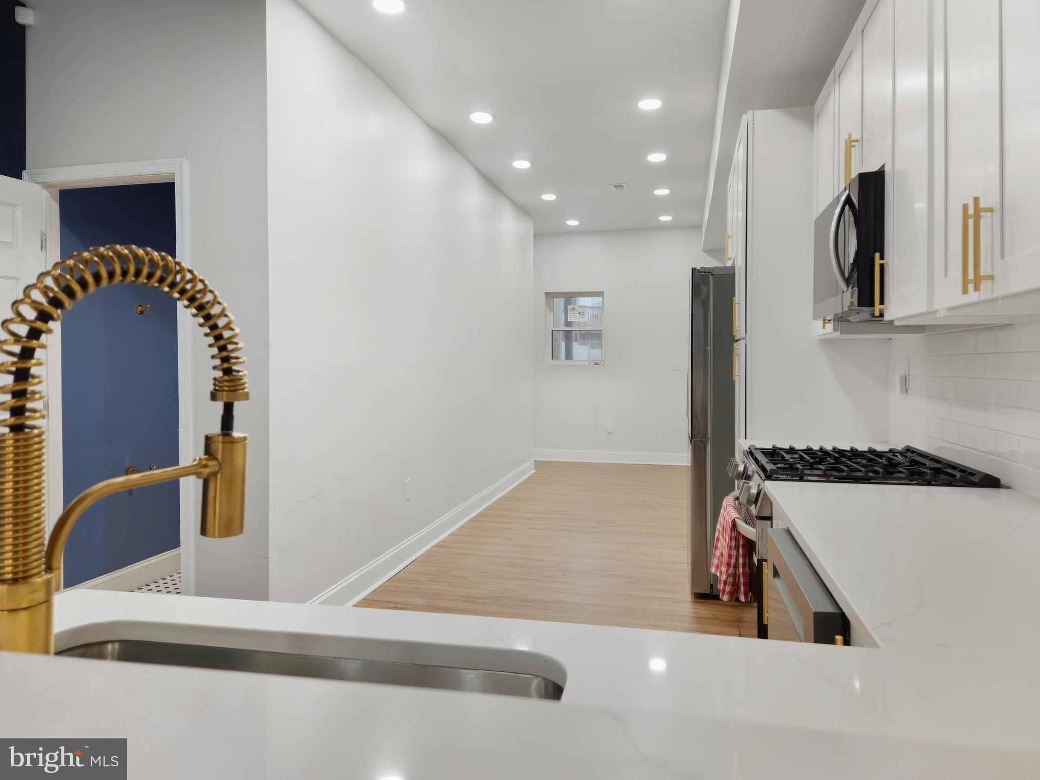 2321 McCulloh Street Baltimore, MD 21217 - Photo 5 of 29 a kitchen with stainless steel appliances granite countertop a sink and a stove