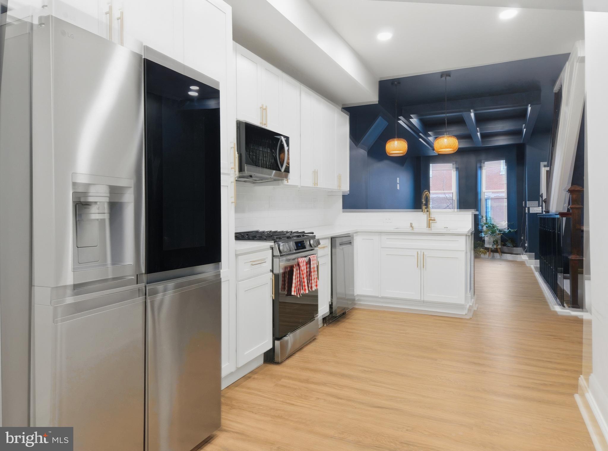 2321 McCulloh Street Baltimore, MD 21217 - Photo 6 of 29 a kitchen with stainless steel appliances a stove top oven a sink and a refrigerator