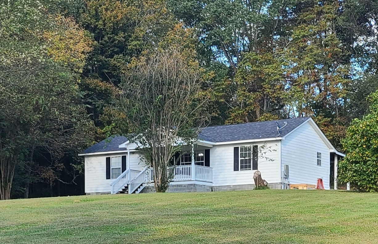 a front view of house with yard and green space