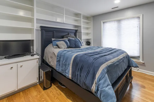 a bedroom with a bed and a flat screen tv