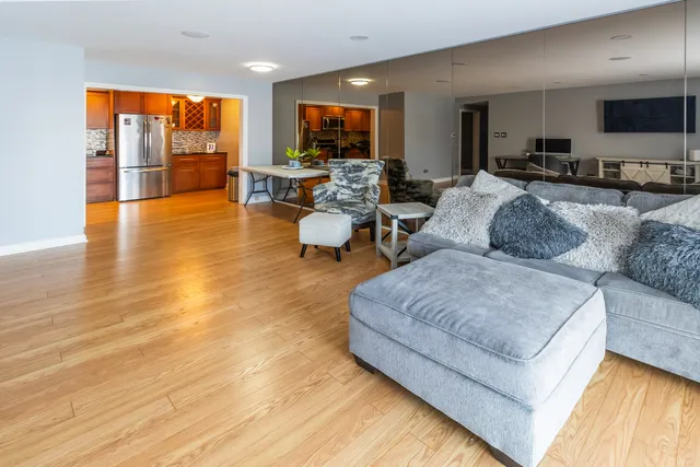 a living room with furniture and large flat screen tv