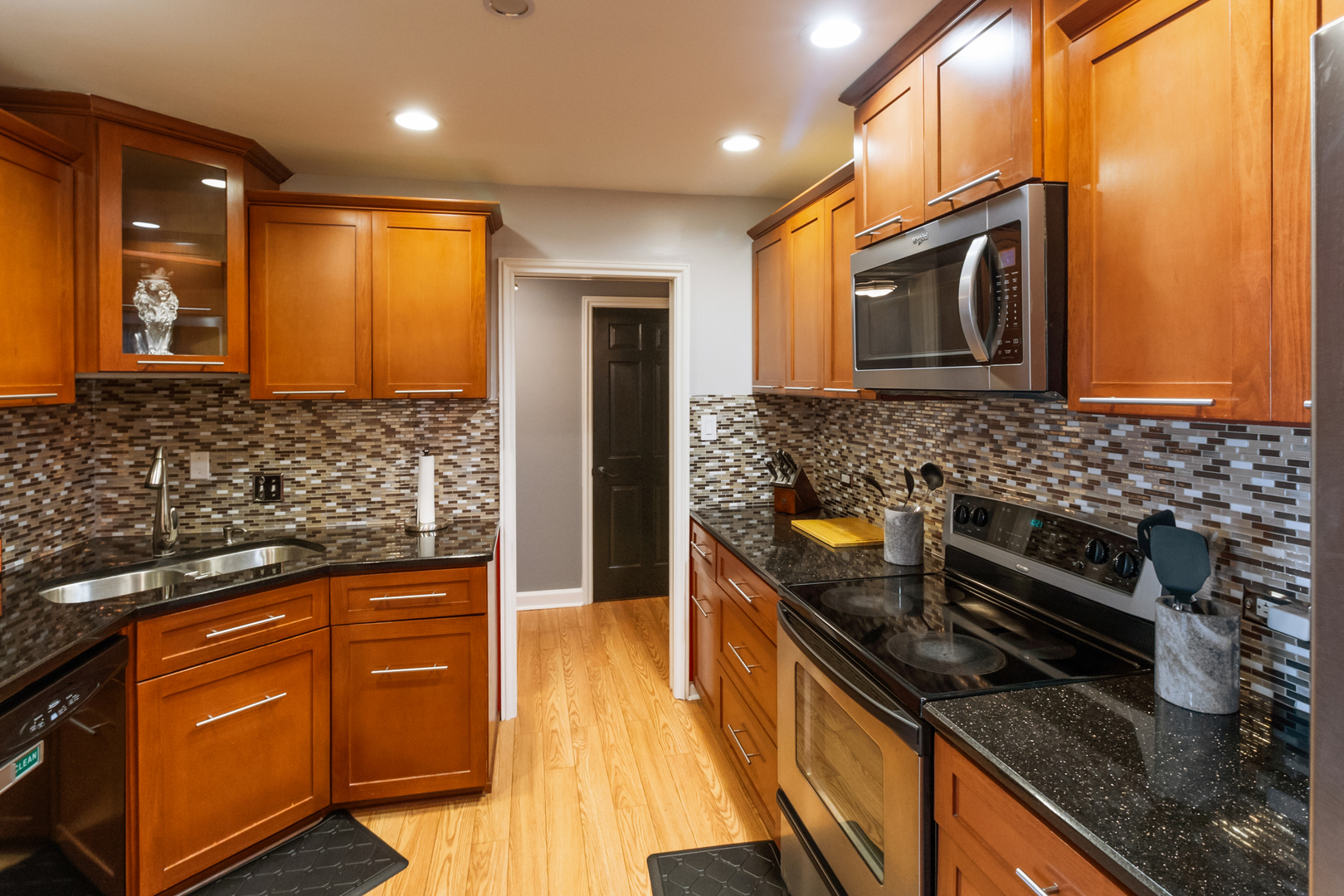 3427 Vollmer Road, Unit 205 Flossmoor, IL 60422 - Photo 4 of 30 a kitchen with granite countertop stainless steel appliances a stove a sink and a microwave