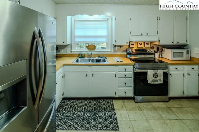 a kitchen with a sink stove and refrigerator