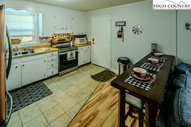 a kitchen with a stove a sink and cabinets