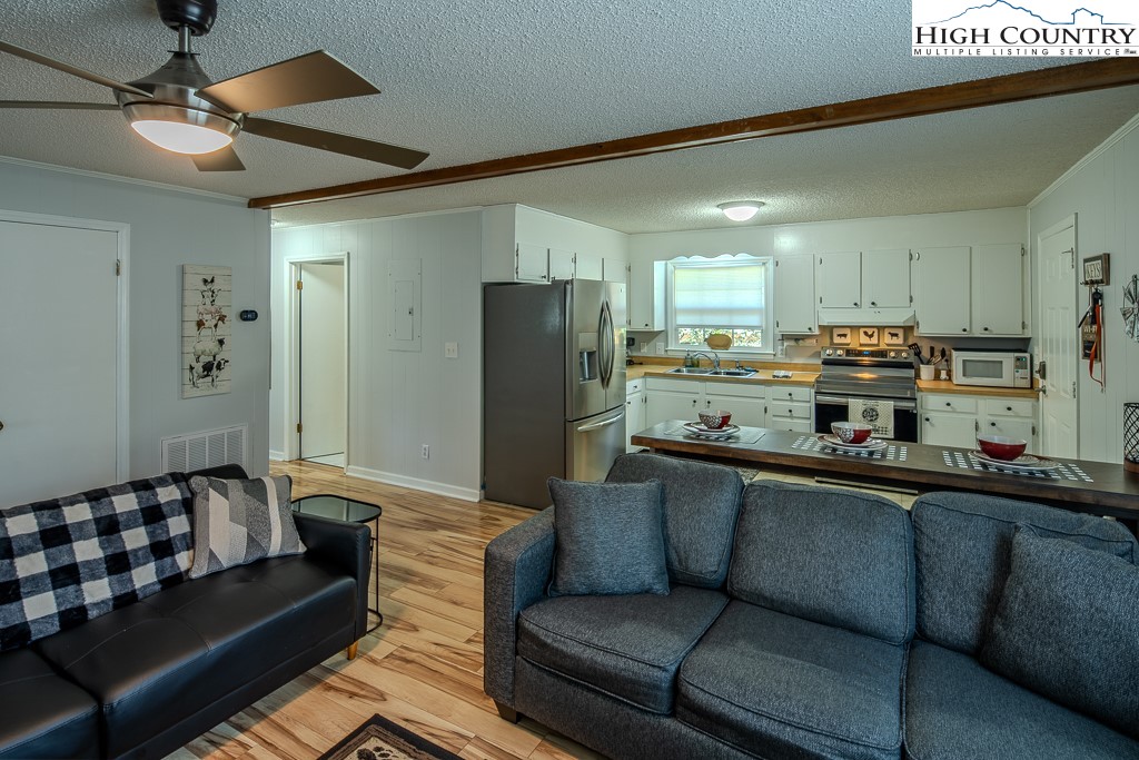 198 Black Pine Road Newland, NC 28657 - Photo 14 of 34 a living room with stainless steel appliances granite countertop furniture and a kitchen view