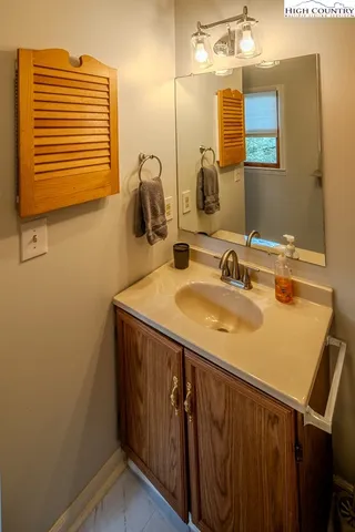 a bedroom with two beds and windows