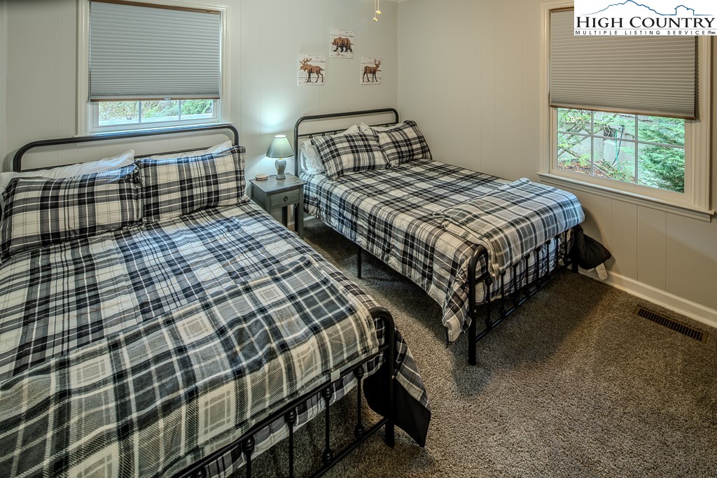 198 Black Pine Road Newland, NC 28657 - Photo 21 of 34 a bedroom with two beds and windows