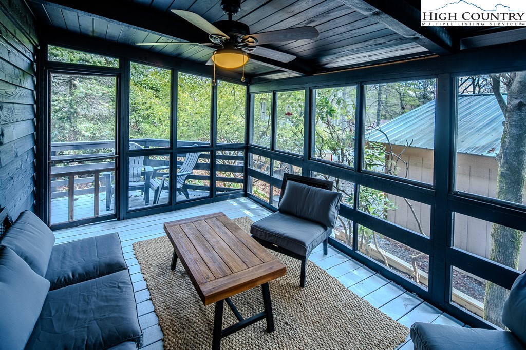 198 Black Pine Road Newland, NC 28657 - Photo 27 of 34 a living room with furniture and a floor to ceiling window