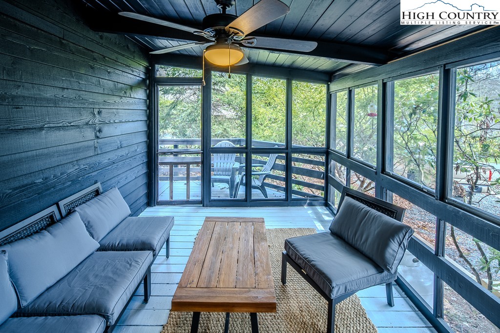 198 Black Pine Road Newland, NC 28657 - Photo 28 of 34 a living room with furniture and a floor to ceiling window