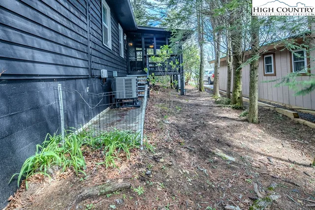 a front view of a house with a tree