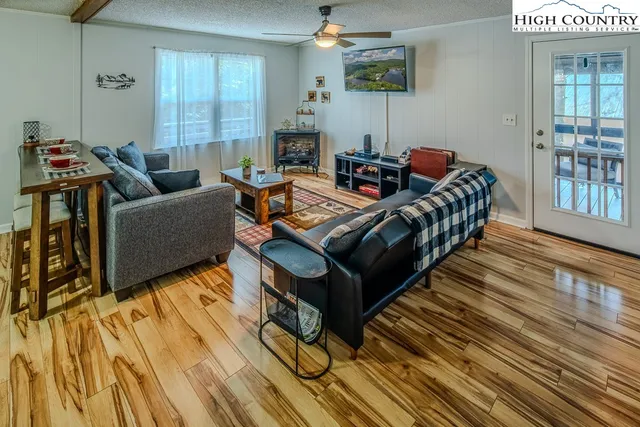 a living room with furniture and a wooden floor