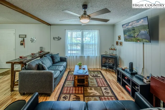 a living room with furniture fireplace and flat screen tv