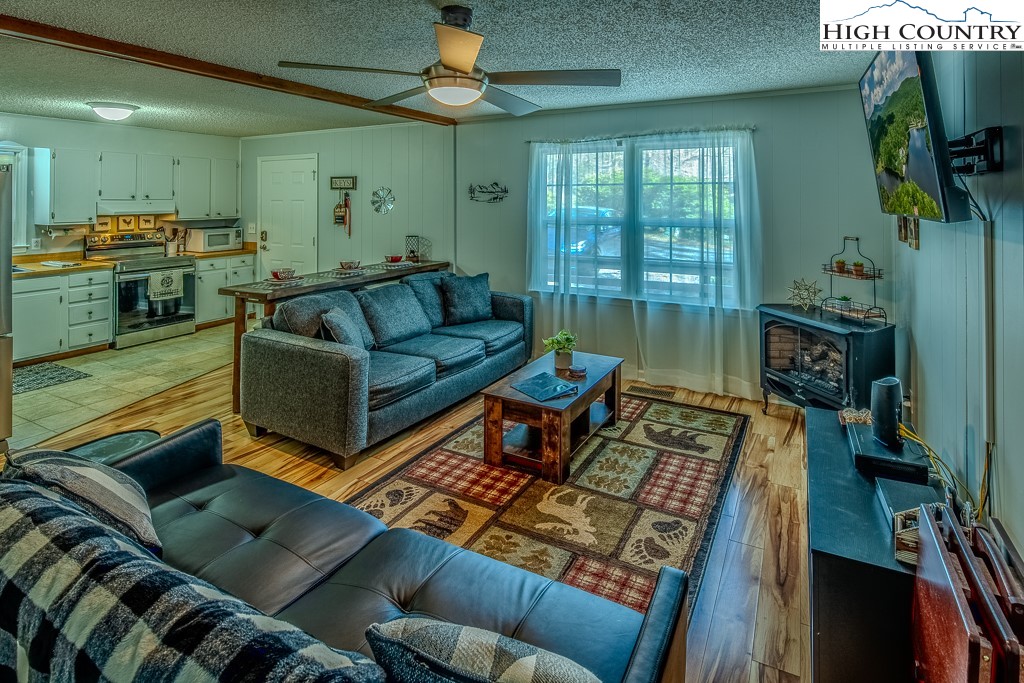 198 Black Pine Road Newland, NC 28657 - Photo 9 of 34 a living room with furniture fireplace and a large window