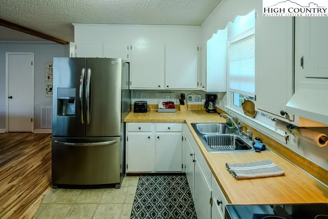 a kitchen with a refrigerator a sink and a stove