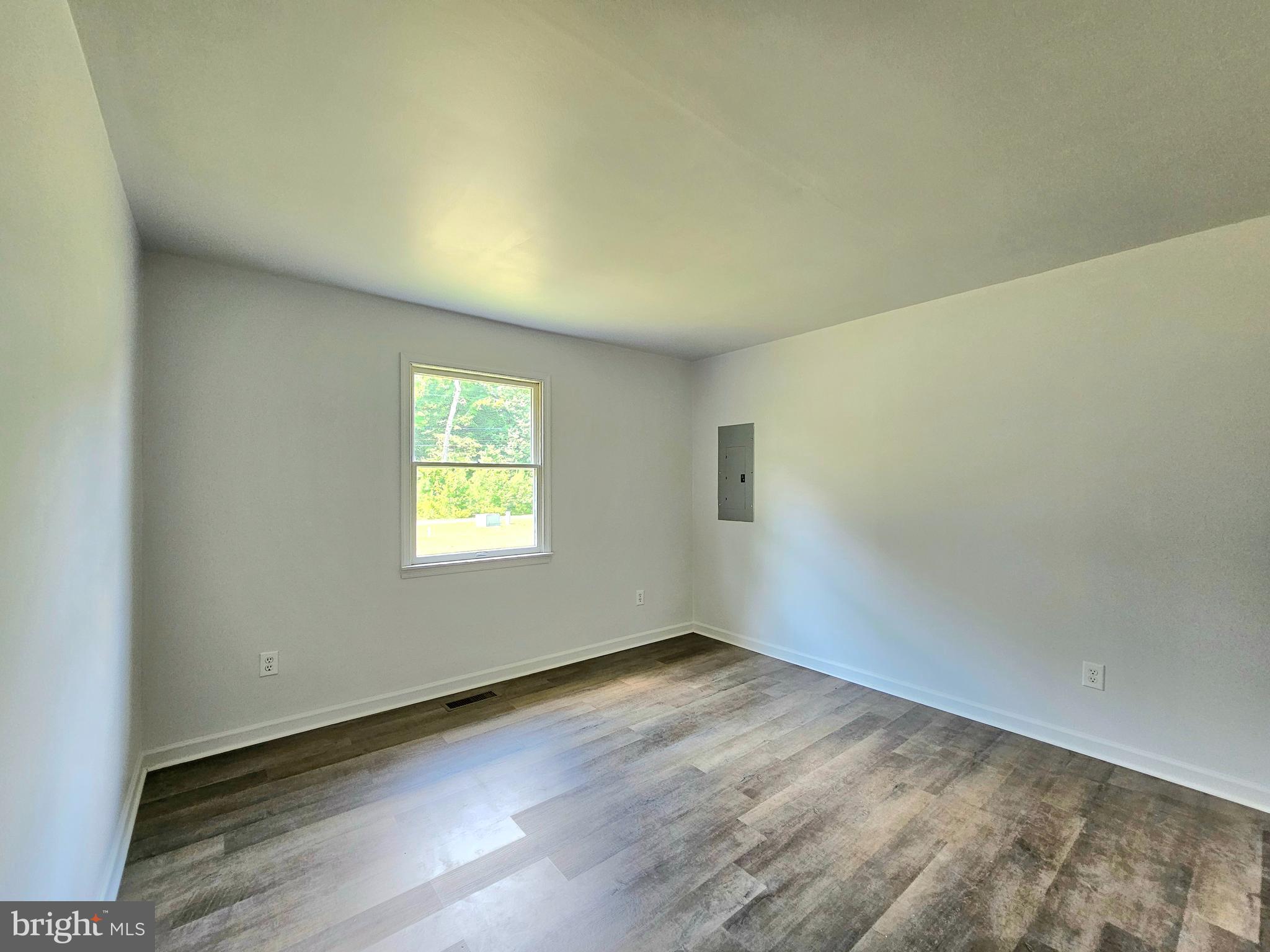 11285 Snethen Church Road Mardela Springs, MD 21837 - Photo 12 of 21 an empty room with wooden floor and windows