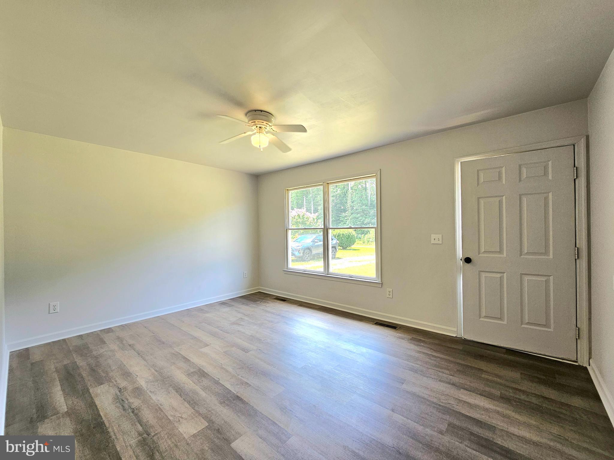 11285 Snethen Church Road Mardela Springs, MD 21837 - Photo 3 of 21 an empty room with wooden floor and windows