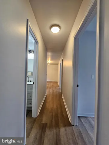a view of a hallway with wooden floor