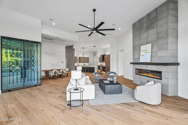 a kitchen with stainless steel appliances kitchen island granite countertop a refrigerator a stove a sink and a oven with wooden floor