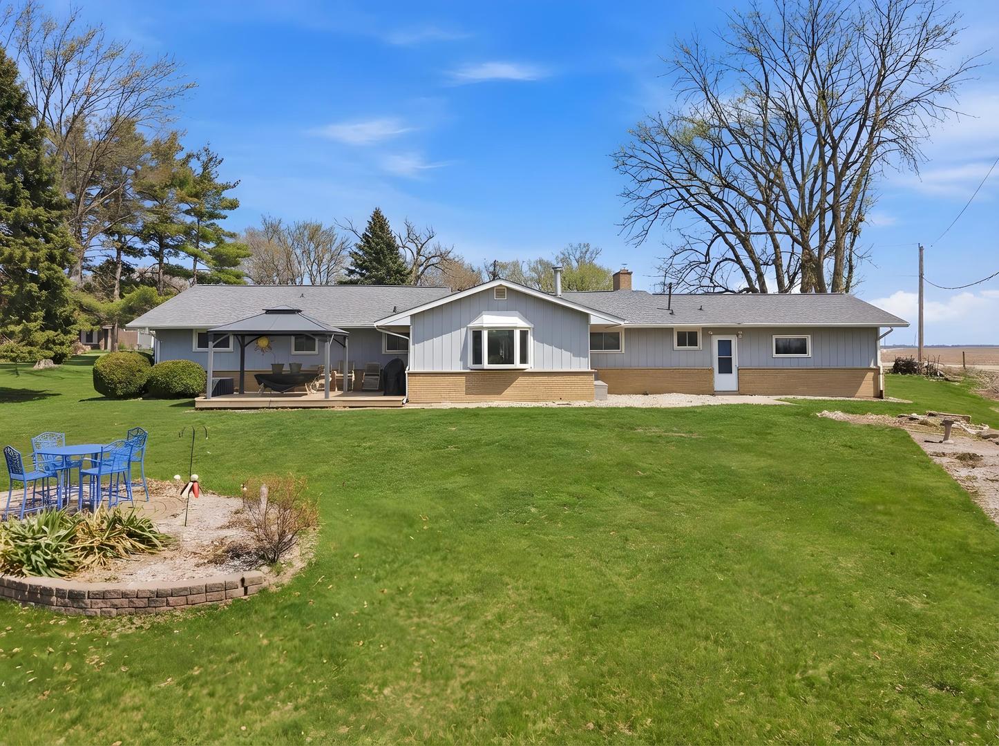 28007 Brickville Road Sycamore, IL 60178 - Photo 25 of 39 a front view of a house with garden and trees