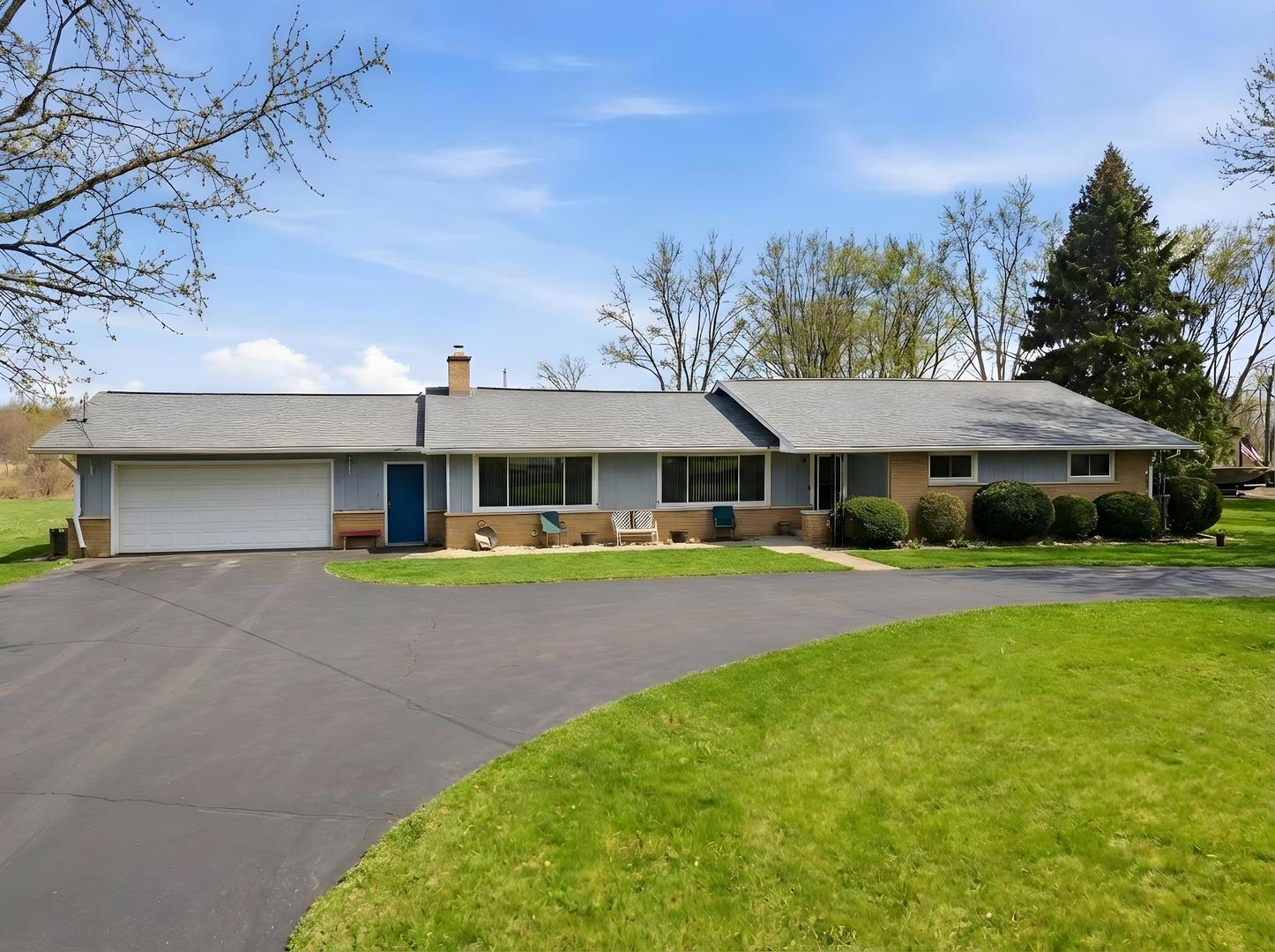28007 Brickville Road Sycamore, IL 60178 - Photo 32 of 39 a front view of a house with a garden and outdoor seating