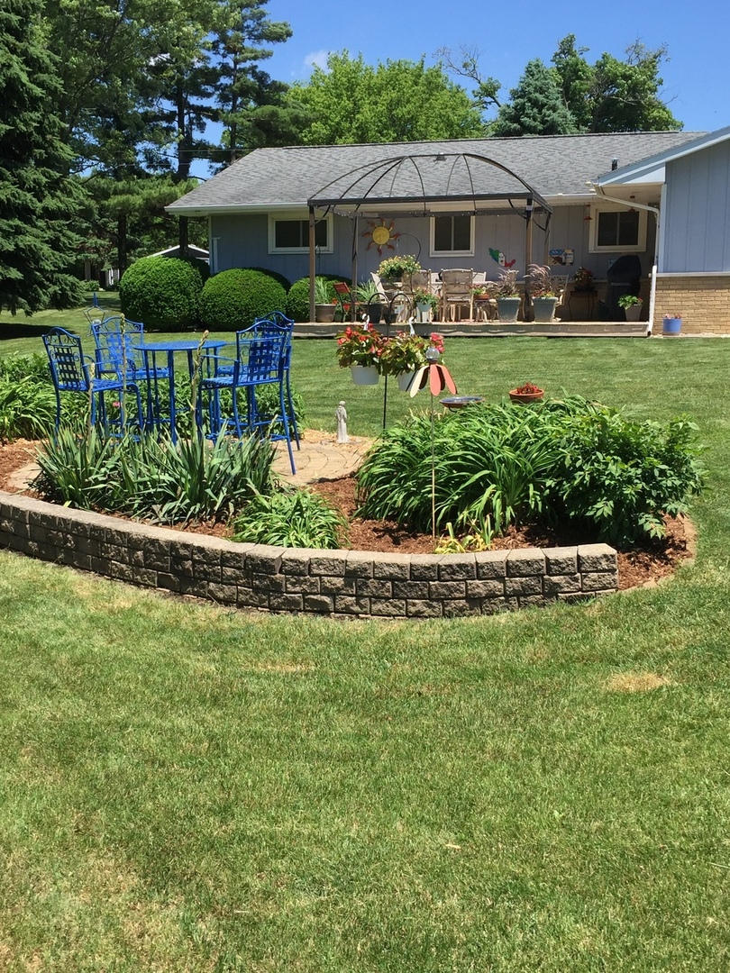 28007 Brickville Road Sycamore, IL 60178 - Photo 38 of 39 a front view of house with a garden and patio