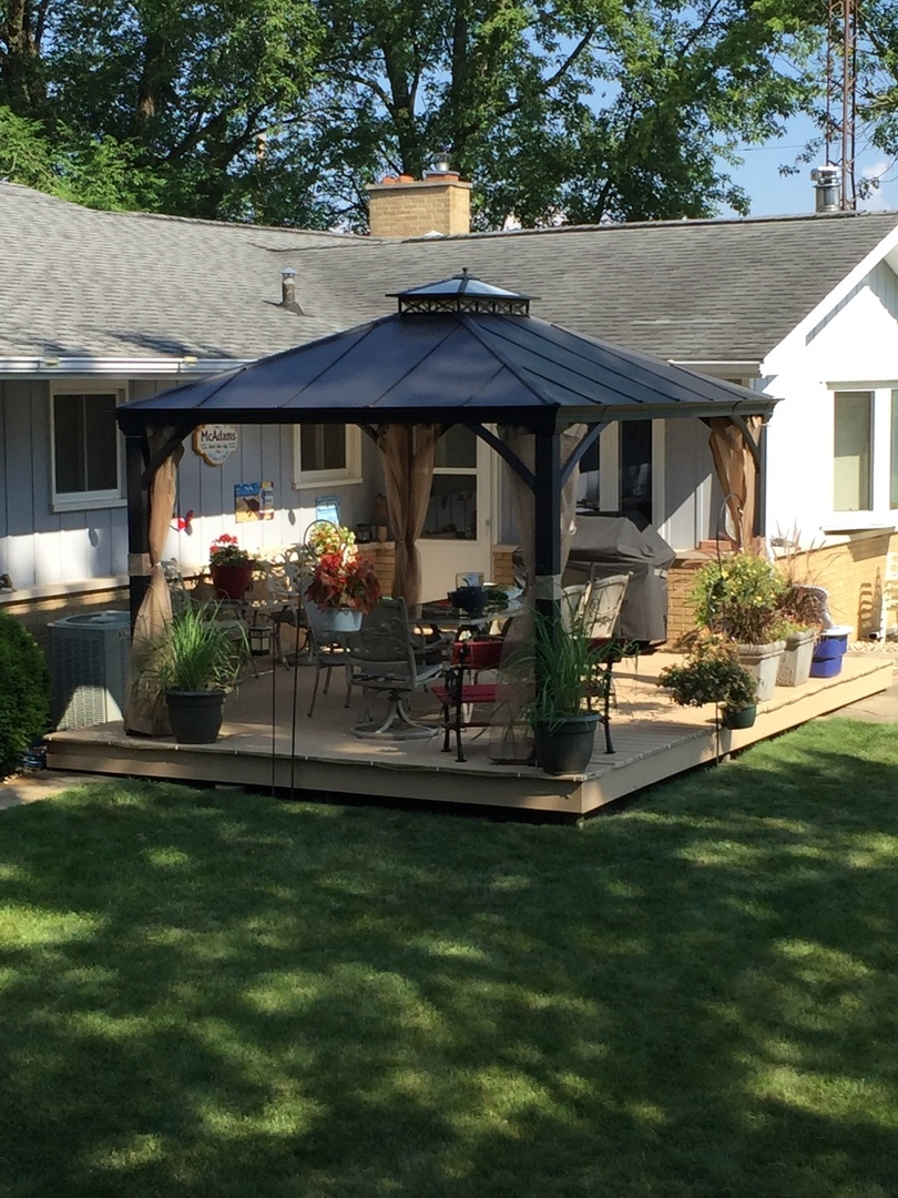 28007 Brickville Road Sycamore, IL 60178 - Photo 39 of 39 a front view of a house with a garden and swimming pool