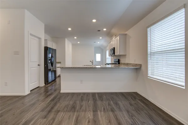 a view of a kitchen with a sink and a refrigerator