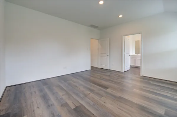 a view of an empty room and wooden floor