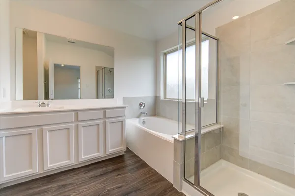 a bathroom with a bathtub and a sink