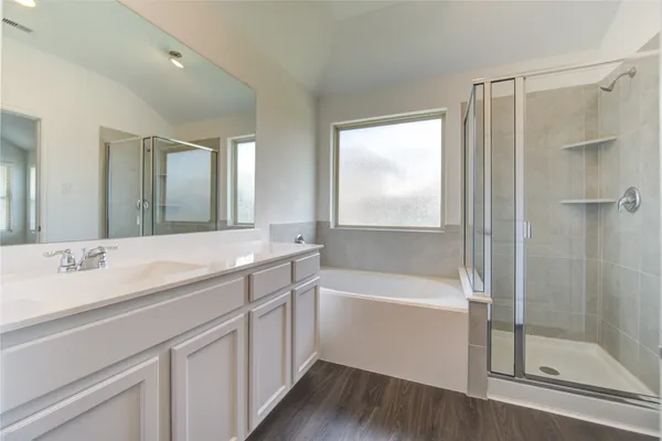 a bathroom with a tub a sink and mirrors