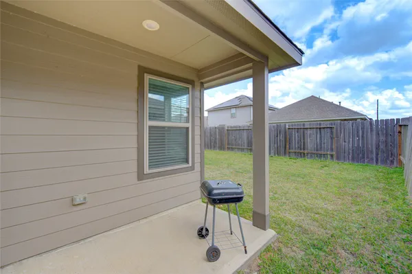 a view of backyard with a chair and table
