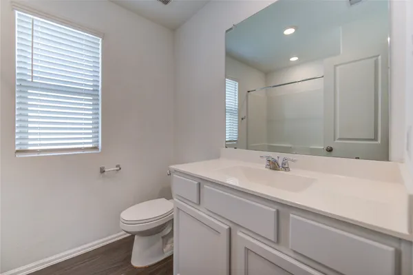 a bathroom with a sink a toilet and mirror